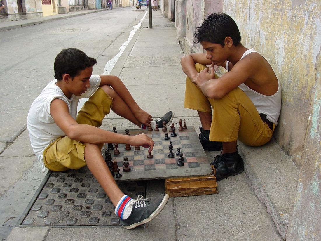 Two young players concentrating over a chess board
